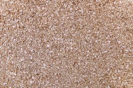 Large pile of beige birch shavings after solid wood processing for furniture production as background upper viewの写真素材