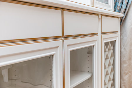 Classical style white showcase with glass doors and gilding extreme closeup viewの写真素材