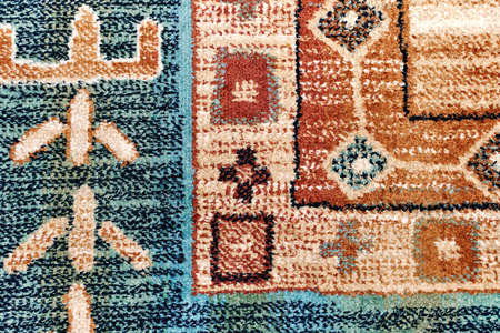 Elegant beige and blue ethnic traditional handmade carpet decorated with colorful patterns lies on...