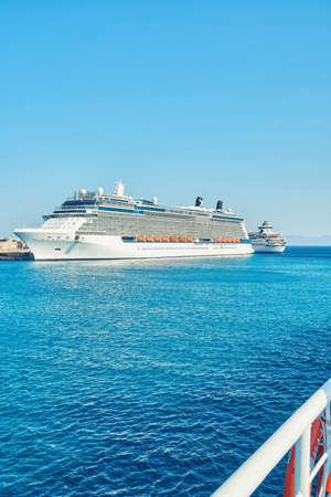 Large white tourist cruise ship on boundless blue rippling sea under clear sky near Rhodes island in...