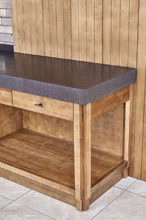 Furniture set of veneer and solid ash timber with acrylic solid surface countertop with figure edge in summer kitchen on open terraceの写真素材