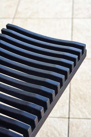Stylish dishes drying rack made of toned black solid ash in summer kitchen extreme close view