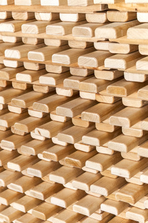 Large stack of new wooden lattices made of natural solid birch in contemporary carpentry warehouse close view as backgroundの写真素材