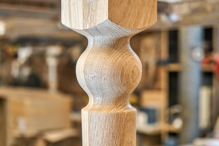 Wooden carved leg of solid oak of dining table in workshop extreme close up viewの写真素材