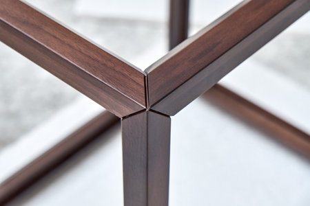 Wooden frame of bedside table made of solid walnut in workshop. Joinery angular joint of planks on dowels closeupの写真素材