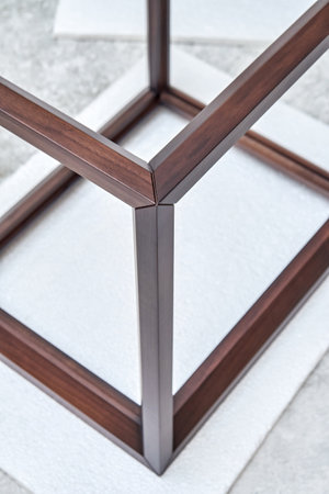 Wooden frame of bedside table made of solid walnut in workshop. Joinery angular joint of planks on dowels closeupの写真素材