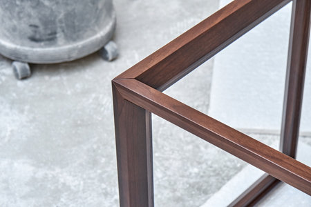 Wooden frame of bedside table made of solid walnut in workshop. Joinery angular joint of planks on dowels closeupの写真素材