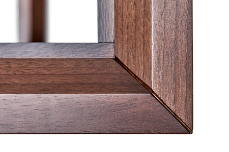 Wooden frame of bedside table made of solid walnut isolated on white background. Joinery angular joint of planks on dowels closeupの写真素材