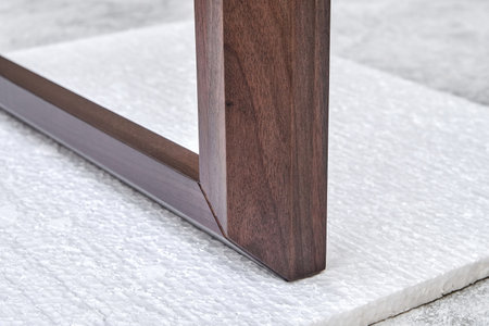 Wooden frame of bedside table made of solid walnut in workshop. Joinery angular joint of planks on dowels closeupの写真素材