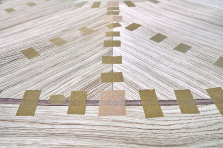 Jointed veneer with tape for table top of dining table with geometric pattern on workbench in workshop closeupの写真素材