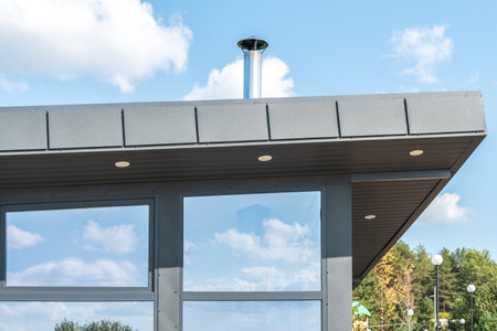 Stylish guest house with panoramic window at resort on summer day. Simple building exterior design for visitors. Glass wall of residential houseの写真素材