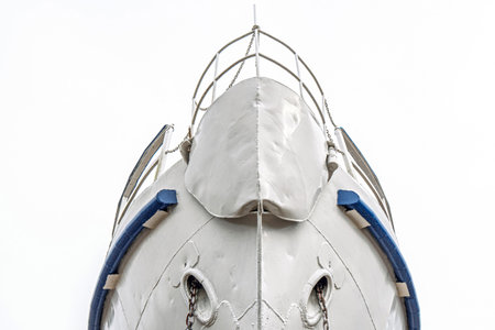 Ship's bow with anchor chains extending from the hawse holes, featuring weathered metal and welded seams close viewの写真素材