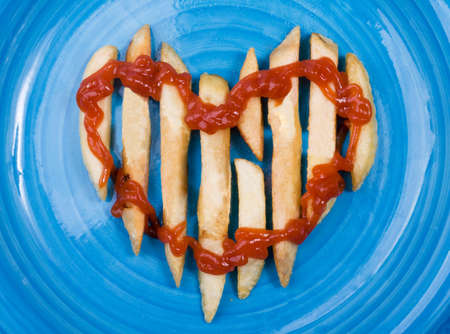 Potatoes in the form of heart on a plateの写真素材