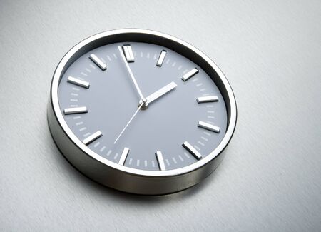 Metal clock on the wall of steel. The concept of timeの写真素材