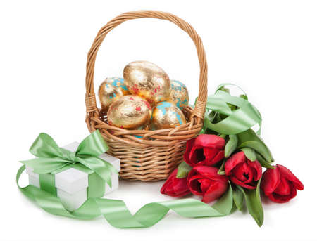 Basket with easter golden eggs on white background