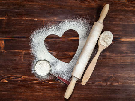 The heart of flour on the table from old boards.の写真素材