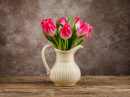 Beautiful tulips bouquet on wooden table. Spring flowersの写真素材