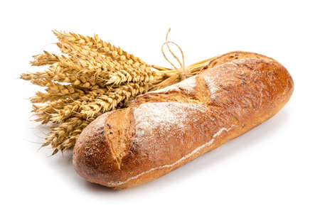 breads and a bunch of wheat spikelets on a white background