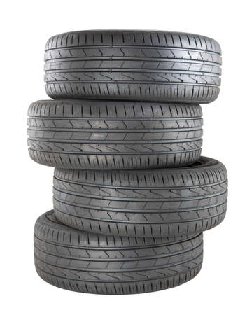 four new black tires for car driving isolated on white background.
