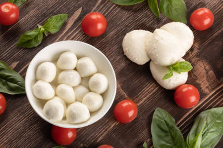 Basil, tomatoes and mozzarella for caprese salad, italian food and mediterranean diet concept.の写真素材