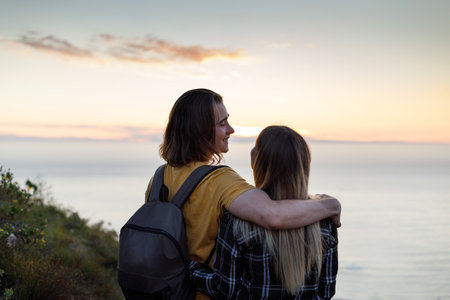 Happy couple walking and talking on a mountain hike