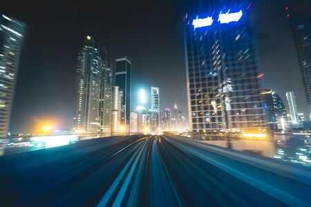 metro track with skyline at night Dubai - UAE