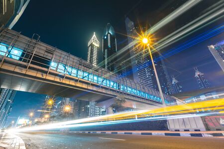 Long exposure of cars passing on highway in front of skyscrapers Dubai - UAE