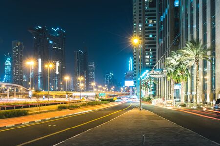 Street at night with passing cars Dubai - UAEの写真素材