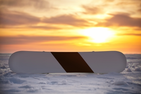 Snowboarding in the snow at sunset, with fasteningの写真素材