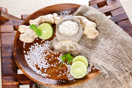 Still life, bags of salt for massage, with flowers, on herbs in the spa on a trayの写真素材