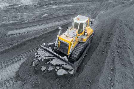 Open pit mine, breed sorting. Mining coal. Bulldozer sorts coal. Extractive industry, anthracite. Coal industry.の写真素材