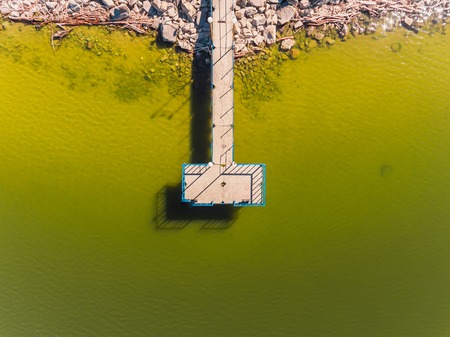 Aerial view of ocean beach. Sand beach and pier view from above. Aerial shot of beach