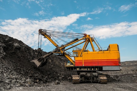 Large quarry dump truck. Loading the rock in dumper. Loading coal into body truck. Production useful minerals. Mining truck mining machinery, to transport coal from open-pit as the coal production.の写真素材