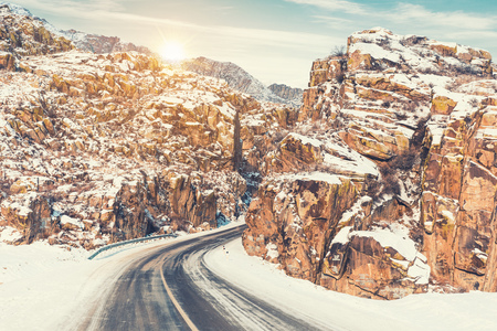 Beautiful winter landscape in the mountains. Winter road in the rocks. Snowy sunrise in the mountainsの写真素材