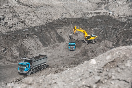 Large quarry dump truck. Loading the rock in dumper. Loading coal into body truck. Production useful minerals. Mining truck mining machinery, to transport coal from open-pit as the Coal Productionの写真素材