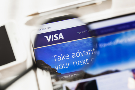 New York, USA - 4 March 2019: Visa Inc. official website homepage under magnifying glass. Concept Visa Inc., Payment systems logo visible on smartphone, tablet screen,のeditorial素材