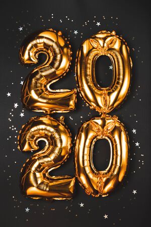 Happy New year 2020 celebration. Bright gold balloons figures, New Year Balloons with glitter stars...