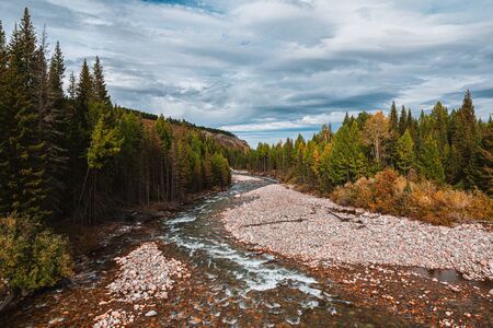 Panorama of mountain river on background of beautiful mountains in cloudy weather. View of turquoise...