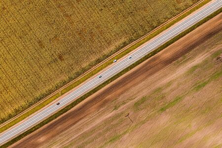 Panorama aerial view shot on road in the fields.Top View of Rural Road. Farm fields from above. aerial view of farm land.の写真素材