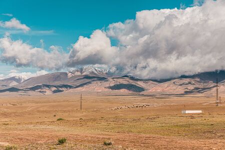 Panorama of desert landscape on  snow-capped mountain peaks.の写真素材
