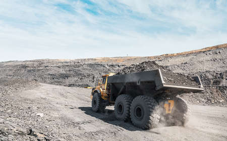 Large quarry dump truck. Loading the rock in dumper. Loading coal into body truck. Production useful...