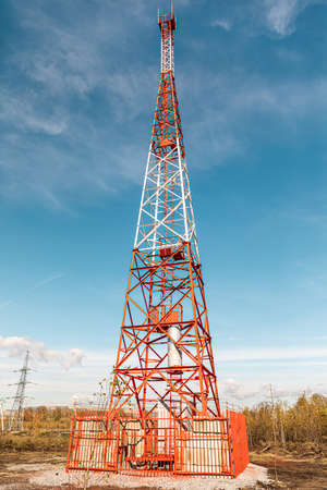 New telecommunication antenna on background of blue sky in the forest. Satellite dish telecom network at communication technology network. Telecom broadcasting tower. Cell towerの写真素材