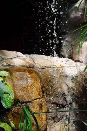 Waterfalls in stones and foliage.の写真素材