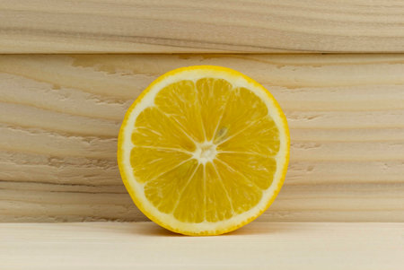cut fresh juicy natural sour lemon on wooden backgroundの写真素材