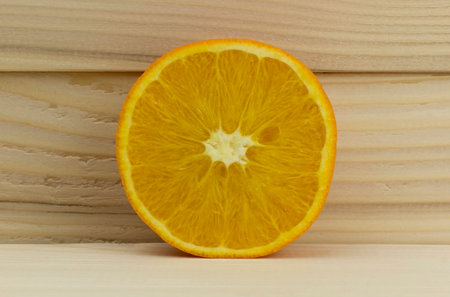 cut fresh juicy natural sour orange on wooden backgroundの写真素材