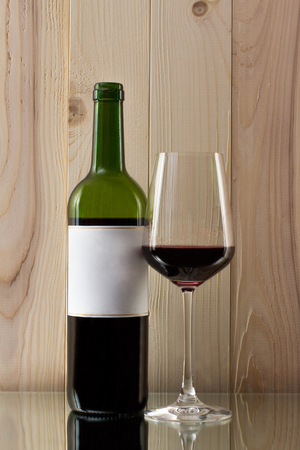bottle of red wine with a brilliant glass on a glass standの写真素材