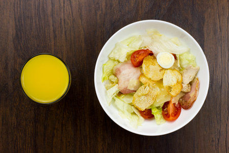 Caesar salad orange juice delicious healthy food tomatoes croutons Parmesan cheese and fresh mozzarellaの写真素材