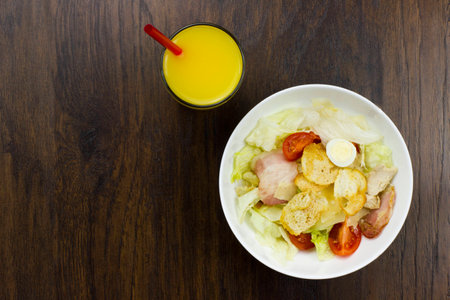 Caesar salad orange juice delicious healthy food tomatoes croutons Parmesan cheese and fresh mozzarellaの写真素材