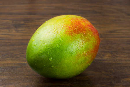 wet mango ripe fresh red green yellow natural vitamins tropical lifeの写真素材