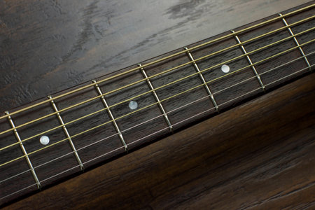acoustic guitar neck fingerboard frets strings music case close inlay creativity art sound vibration play music guitaristの写真素材